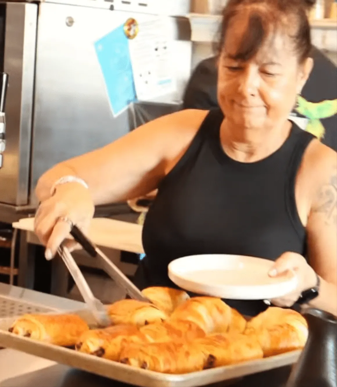 croissants and Pastries at 5350 The Pourhouse lady taking pastries from the oven