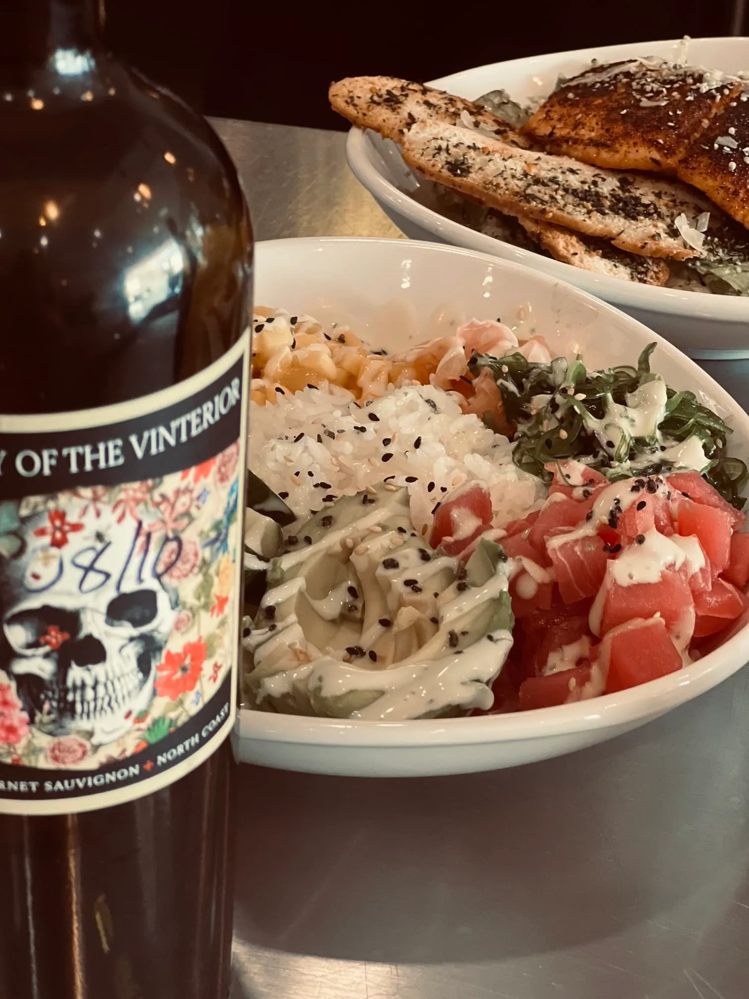 Salad next to wine.